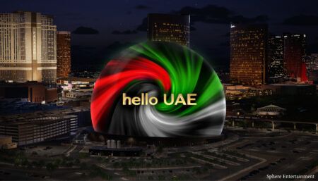 Sphere lit up at night with the colours of UAE flag, and message saying 'hello UAE'