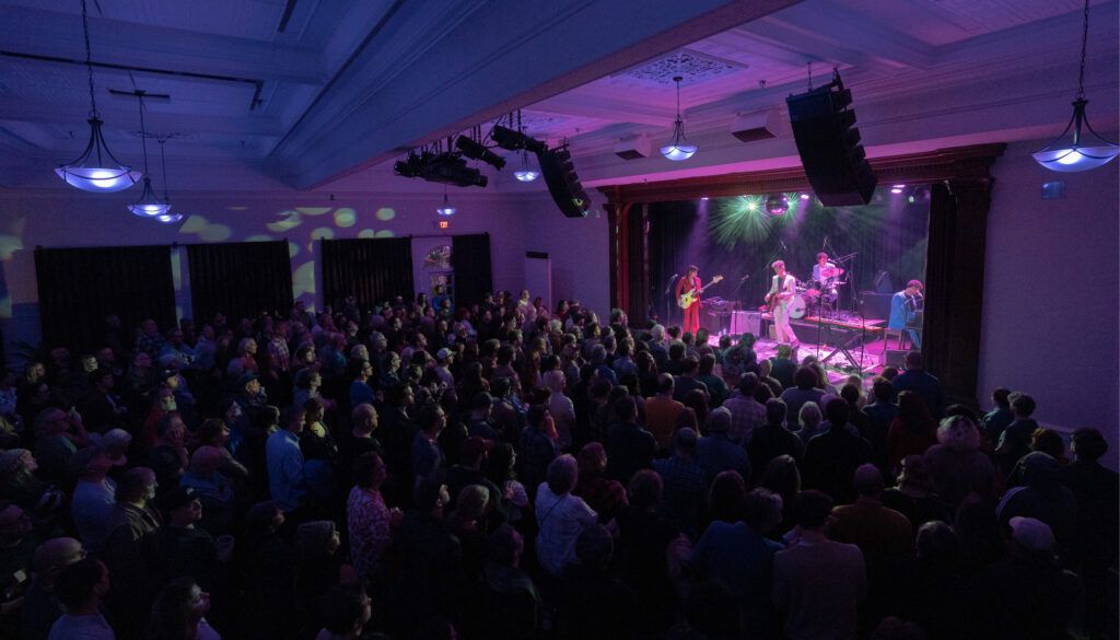 Concert at events space with band on stage in front of crowd