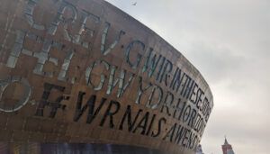 Close-up view of Wales Millennium Centre's distinctive bronze dome with carved Welsh and English text