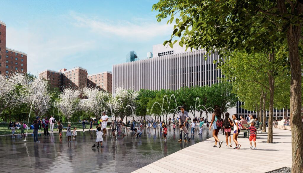 Public plaza with water feature and blooming trees. People interact with shallow reflecting pool while modern buildings frame the space.