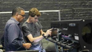 Two men examining professional lighting equipment