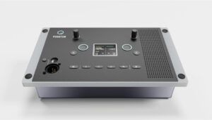 Professional audio intercom control panel with two knobs, buttons, display screen, speaker grille, and connector on silver chassis