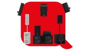 Collection of black and white professional audio speakers and subwoofers arranged on red background