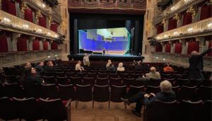 Ornate theatre interior with people at seminar
