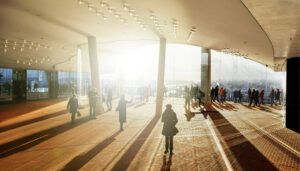Modern covered space with glass doors out to viewing area, with people walking, dramatic shadows cast by bright sunlight
