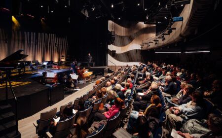 Concert hall with instrumentalists on stage in front of seated audience