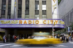 Exterior of Radio City Music Hall with yellow taxi outside