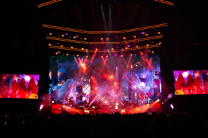 Concert stage with colourful lights and large video screens