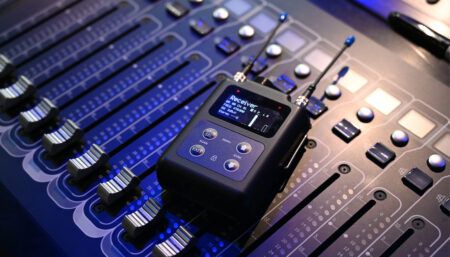 Wireless receiver device placed on professional audio mixing console