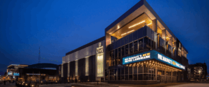Exterior of Landmark Credit Union Live venue in Milwaukee at dusk, with illuminated signage reading "Milwaukee's New Music Landmark" on the glazed facade.