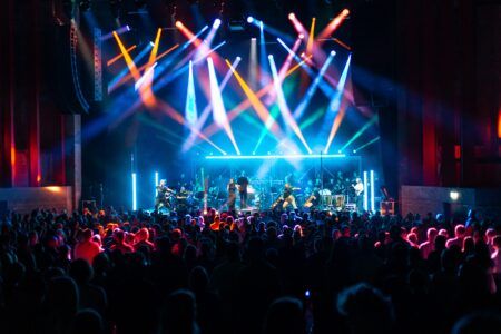 Concert at Bradford Live, showing an orchestra and vocalists performing with a full crowd in the foreground