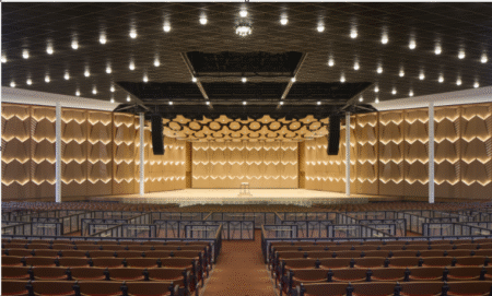 Wenger completes motorised acoustical shell at Ravinia’s Hunter Pavilion Interior of Ravinia’s Hunter Pavilion showing the illuminated chevron-patterned acoustical shell walls surrounding the stage, with rows of seating in the foreground