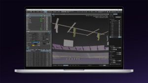 A laptop screen showing the ArrayCalc V13 Beta interface, with a 3D plot of flown line array loudspeakers arranged above a virtual venue and audience seating.